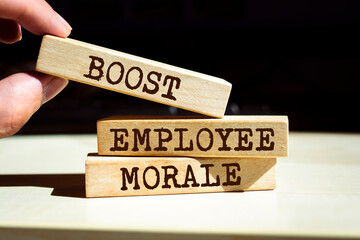 Wooden blocks with words 'BOOST EMPLOYEE MORALE'. Business concept