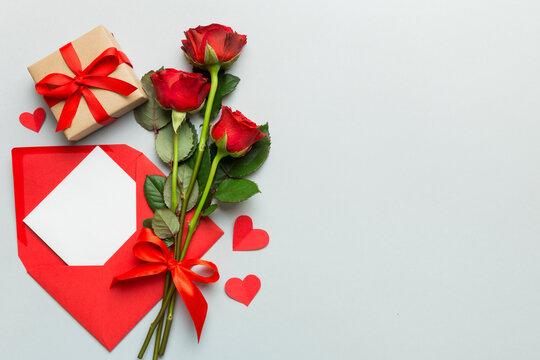 Valentine day composition with Envelope, rose flower and Red heart on table. Top view, flat lay. Holiday concept