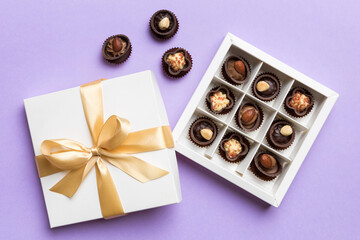 White box with chocolates candies and golden tape. top view with copy space