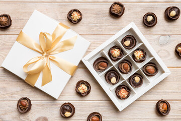 White box with chocolates candies and golden tape. top view with copy space