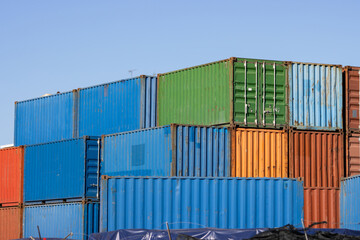 Fototapeta premium Multicolored cargo containers on a blue sky background