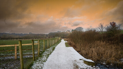 landscape with snow. Wonderful view of snow and colorful sky on the horse farm road.