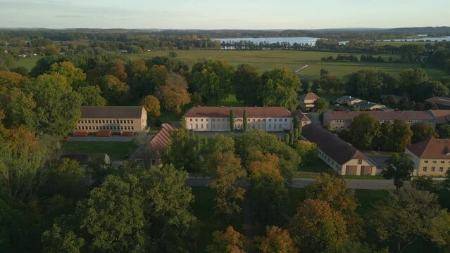 equestrian estate at sunset. Spectacular aerial view flight panorama overview drone of
Paretz castle in brandenburg havelland Germany at summer evening 2022. High Quality 4k Cinematic footage