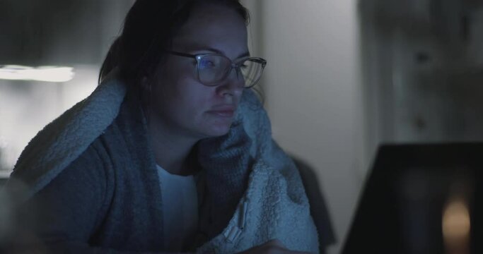 Late Night Emailing: freezing woman Wrapped in a warm Blanket
