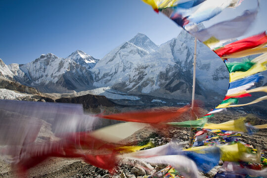 Prayer flags streaming in the wind frame a view of Mt. Everest, Khumbu Glacier, Nepal.