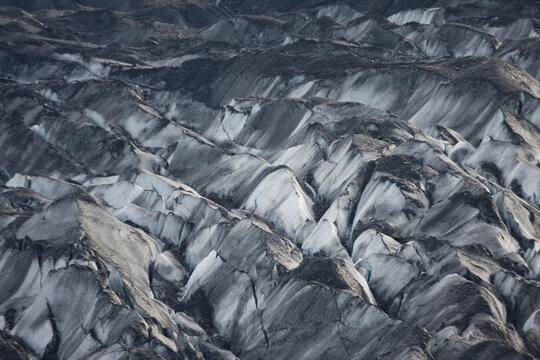 Dead ice lays partially buried under debris along the edge of the Columbia Glacier, near Valdez, Alaska.