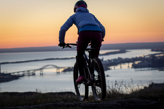 Person riding bicycle at dawn, Duluth, Minnesota, USA