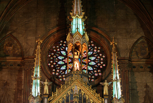 Statues and old painted glass window in San Sebastian Church, Manila, Philippines