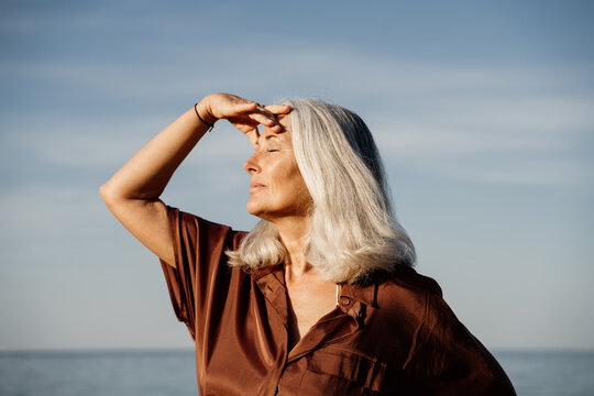 Grey hair mature woman beach portrait 