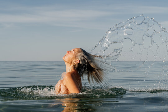 Mature woman swimming beach sea