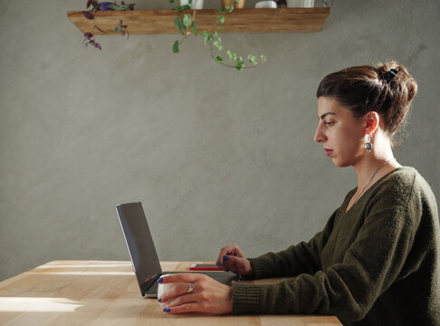 Young woman works on laptop
