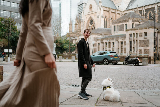 Couple with a dog have fun in the city