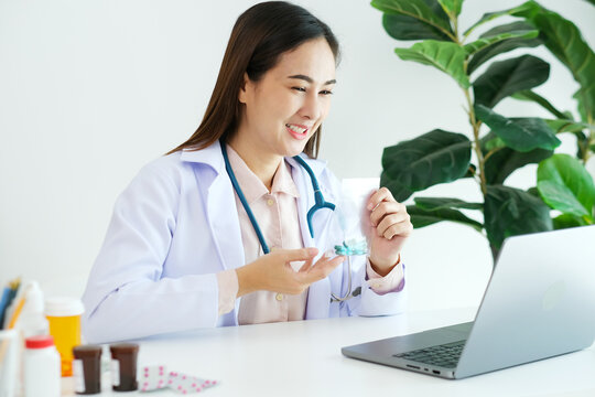 Asian woman doctor make video call counselling her patient about healthcare by laptop computer, Telemedicine, Pharmacist