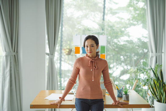 Stylish attractive young businesswoman with a lovely smile standing