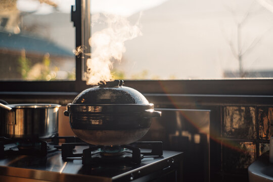 Burning Earthenware pod on stove to make some rice in kitchen
