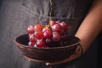a bowl of juicy red grapes