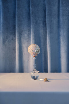 Abstract balancing composition of broken glass, ball and shell