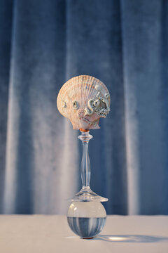Abstract balancing composition of broken glass, ball and shell