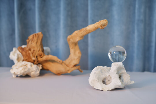 Abstract composition of stones, driftwood and a glass ball