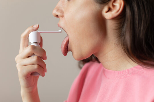 woman spraying her throat
