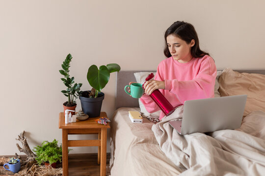 girl pouring tea from a thermo mug