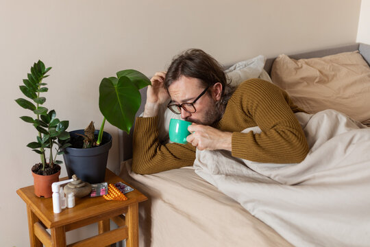 man drinking tea lying down