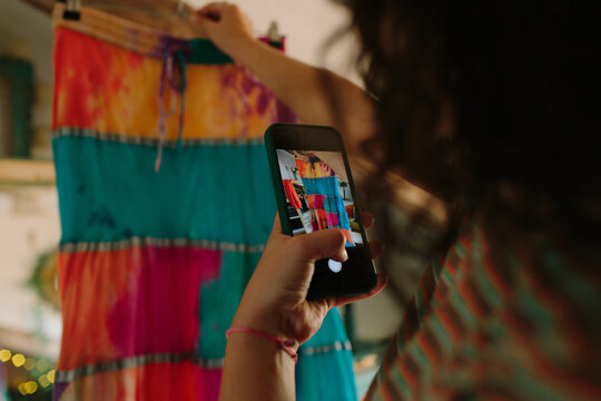 Anonymous girl shooting a photo of a skirt