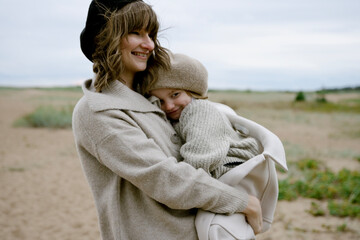 Happy mother with daughter on the beach
