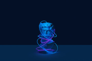 Antique statue covered in color neon strip.