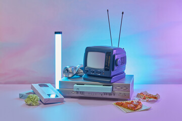 Old TV and VCR player with old VHS cassettes.