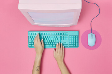 CRT monitor with mouse and keyboard with hands.
