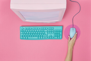 90s monitor and keyboard and mouse held by woman.