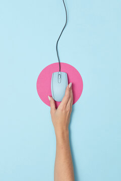 Vintage computer mouse held by woman's hand.