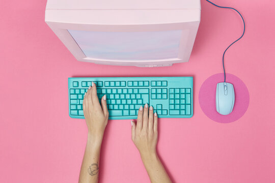 CRT monitor with mouse and keyboard with hands.