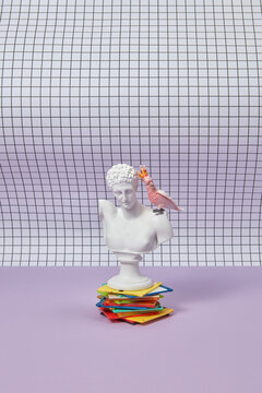 Multicolored floppy disk pile with greek bust.