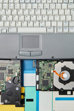 90s laptop with hardware and vintage floppy disk.