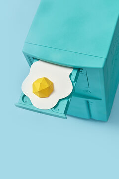 Retro computer with papercraft egg in CD drive.