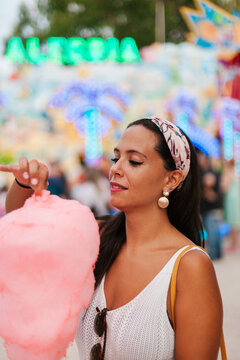 Hispanic woman trying cotton candy