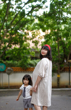 Asian mom and daughter in the garden