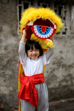 Asian little girl is playing lion dance