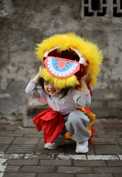 Asian little girl is playing lion dance