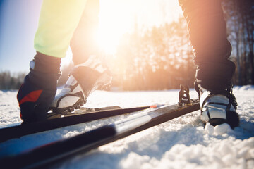 Winter sports for health, Athlete trains cross country skiing on snow, sunny morning day