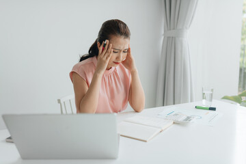 Stressed Businesswoman Sitting In Office With Financial Report