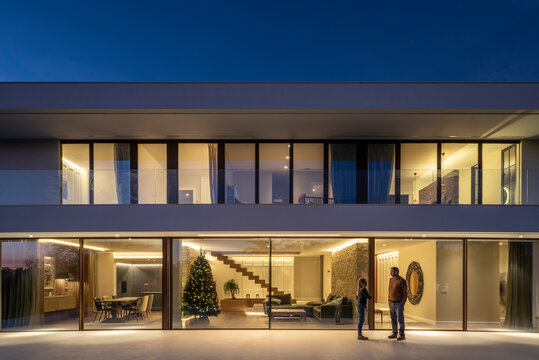 Modern residential family house facade with the interior illuminated