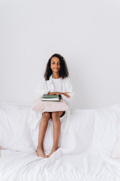 Girl with notebook sitting on sofa