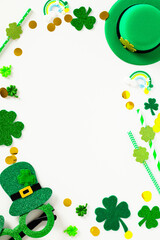 St Patrick's Day vertical banner template. Frame made of Saint Patricks Day party decorations, leprechauns hat, glasses, shamrock on white background. St Patrick's Day party invitation design.