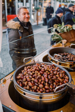 Man getting roasted chestnuts on the Christmas Market