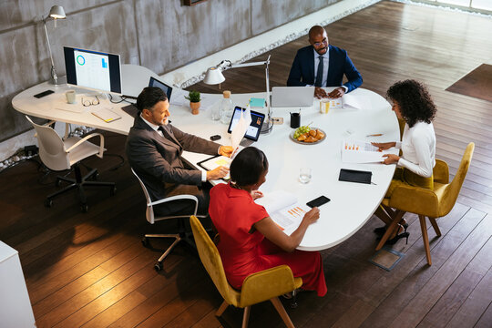 Group of diverse colleagues discussing project in office