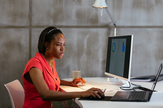 Focused woman working on computer in office