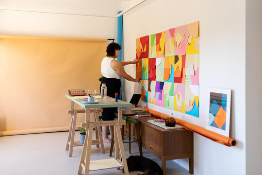 Woman making rainbow mural in her studio